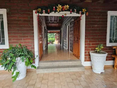 an entry way to a brick house with areath and flowers at Finca la Querendona in Santa Fe de Antioquia