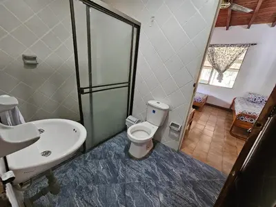 a bathroom with a toilet and a sink at Finca la Querendona in Santa Fe de Antioquia