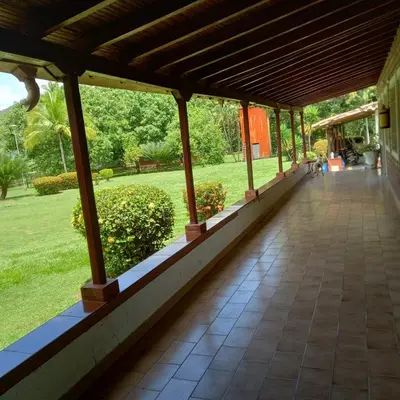 a walkway in a building with a view of a park at Finca la Querendona in Santa Fe de Antioquia