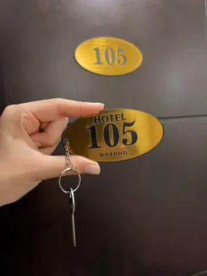 a person holding a key in front of a door at Katara Boutique Hotel in Mariquita