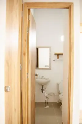 a bathroom with a toilet and a sink at Apartamento amplio cerca al parque Guatape - Pajaros in Guatapé