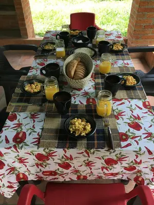 a table with food and glasses of orange juice at Casa Guali in Honda