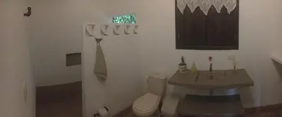 a bathroom with a toilet and a sink at Casa Guali in Honda