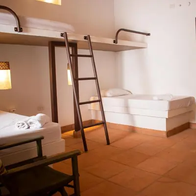 a room with two bunk beds and a ladder at Casa Guali in Honda