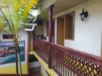 a porch of a house with a palm tree at Hotel Colonial in Jardin