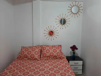a bedroom with a bed and two mirrors on the wall at Espectacular apartamento primer piso capacidad 6 personas in Villamaría