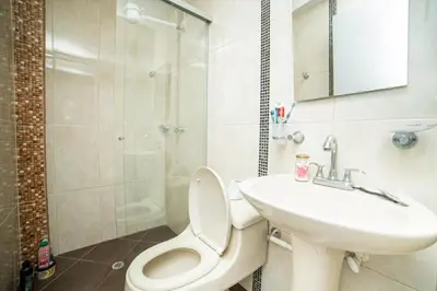 a bathroom with a toilet and a sink and a shower at Descansa en Habitación Privada en Medellín C in Medellín