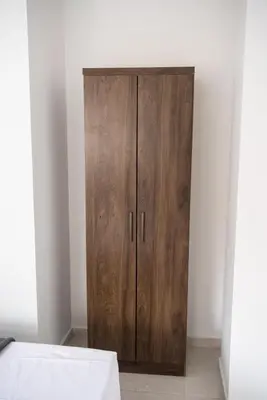 a wooden cabinet in the corner of a room at Descansa en Habitación Privada en Medellín C in Medellín