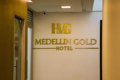 a door to a medicine gold hotel in a building at hotel medellin gold in Medellín