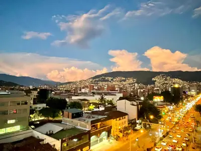 a city skyline at night with a lot of traffic at Apartamento en Laurels Medellín in Medellín
