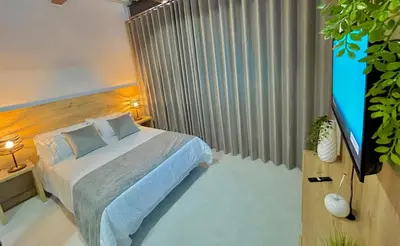 a bedroom with a bed and a flat screen tv at Apartamento en Laurels Medellín in Medellín