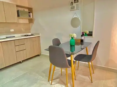 a dining room table and chairs in a kitchen at Apartamento en Laurels Medellín in Medellín