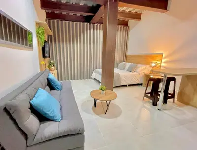 a living room with a couch and a bed at Apartamento en Laurels Medellín in Medellín
