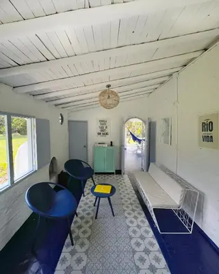 a living room with two tables and a couch at Hermosa Casa frente al Río in San Rafael