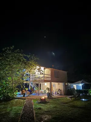 a house at night with a fire in the yard at Hermosa Casa frente al Río in San Rafael