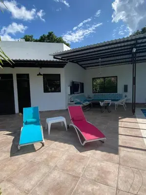 two colorful chairs and tables in a patio at Extraordinaria casa con piscina y pura naturaleza Honda in Honda