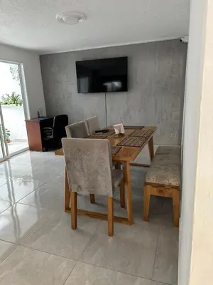 a dining room with a wooden table and chairs at Gaston2 in Medellín