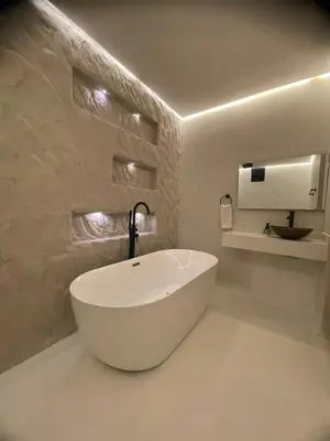 a bathroom with a large white tub in a room at HOTEL BALI AT POBLADO in Medellín