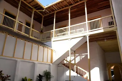 a large building with white walls and wooden ceilings at Casa típica Salamineña in Salamina