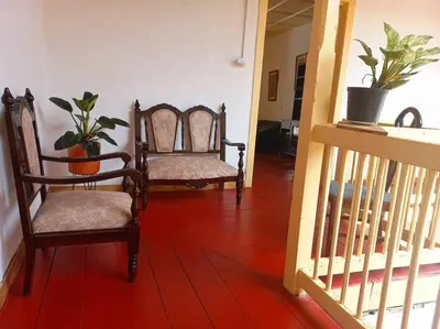 a living room with two chairs and a staircase at Casa típica Salamineña in Salamina