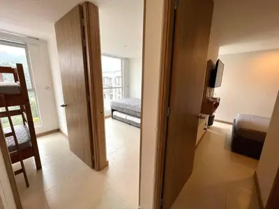 a room with a door leading to a bedroom at Espectacular vista cerca a cable plaza con Piscina in Manizales