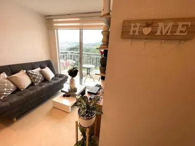 a living room with a couch and a balcony at Espectacular vista cerca a cable plaza con Piscina in Manizales