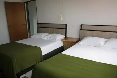 two beds sitting next to each other in a room at Aparta Suite Torre De Prado Penthouse in Medellín
