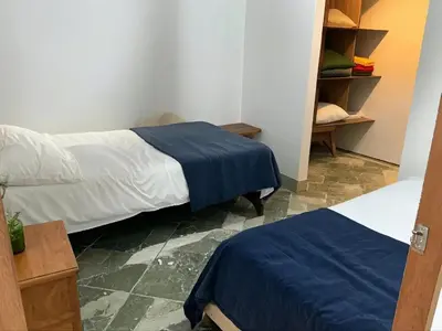 a bedroom with two beds and a closet at Aparta Suite Torre De Prado Penthouse in Medellín