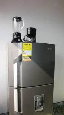 a blender sitting on top of a refrigerator at Aparta Suite Torre De Prado Penthouse in Medellín