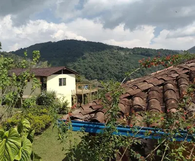 a house and a building with a roof at Finca Emilio in Fredonia