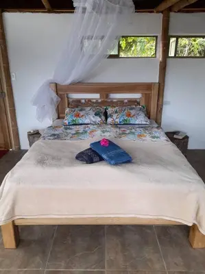 a bedroom with a bed with two pillows on it at Finca Emilio in Fredonia
