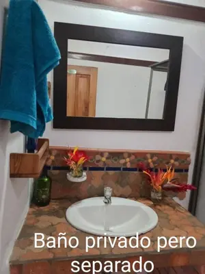 a bathroom with a sink and a mirror at Finca Emilio in Fredonia