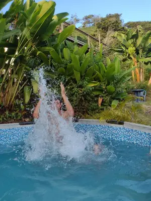 a person is jumping into a swimming pool at Finca Emilio in Fredonia