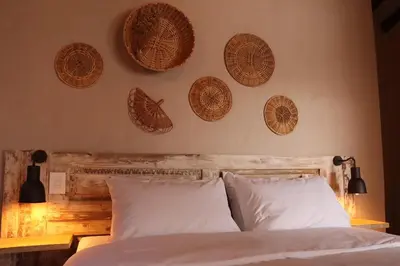 a bedroom with a bed with wicker baskets on the wall at Valerio Hotel Boutique in Marinilla