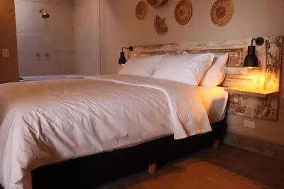 a bedroom with a bed with a wooden head board at Valerio Hotel Boutique in Marinilla