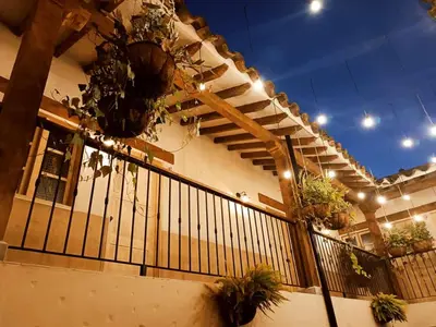 a building with potted plants on a railing at Valerio Hotel Boutique in Marinilla