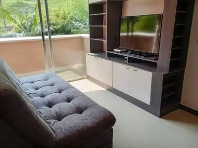 a living room with a couch and a tv at RentalsOP AN01 Apto cerca al lleras con balcon y piscina climatizada, cerca a provenza, ubicado min del aeropuerto in Medellín