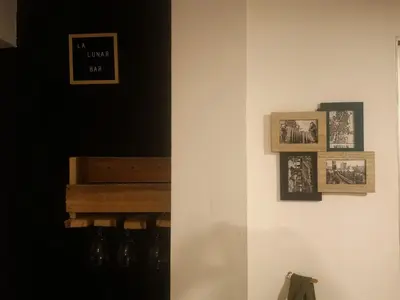 a room with a wall with pictures on it at La Lunar un espacio ideal para trabajar y conocer Medellín in Medellín
