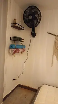 a fan is hanging on a wall in a room at La Lunar un espacio ideal para trabajar y conocer Medellín in Medellín