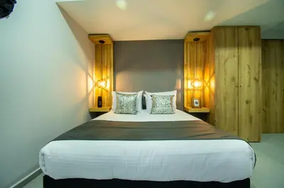 a bedroom with a large bed with two lamps at Barcelo Coliving in Medellín
