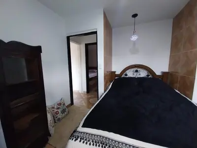 a bedroom with a bed with a black comforter at Los balconesll in Medellín