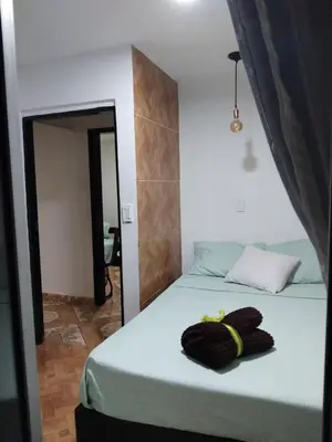 a bedroom with a bed with a towel on it at Los balconesll in Medellín