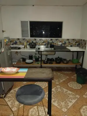 a kitchen with a counter with a sink and a table at Los balconesll in Medellín