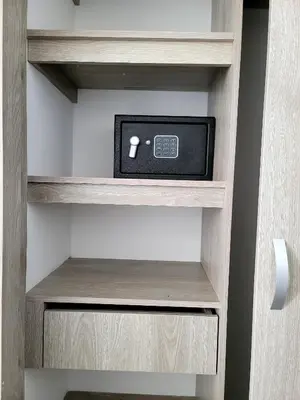 a cabinet with a tv in it at Modern High-Rise 2/2 Apartment with City View. in Sabaneta