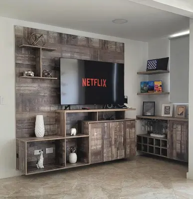 a living room with a television on a wooden wall at Modern High-Rise 2/2 Apartment with City View. in Sabaneta