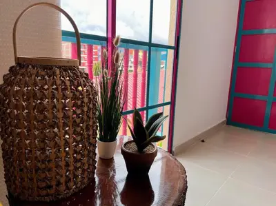 a table with two potted plants on top of it at Apto Nuevo, Tranquilo, Bonito, 5 min Plaza Principal in Guatapé
