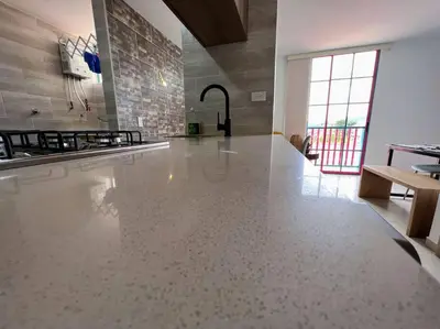 a kitchen with a white tile floor in a room at Apto Nuevo, Tranquilo, Bonito, 5 min Plaza Principal in Guatapé