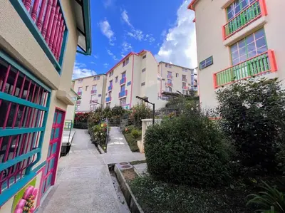 a walkway between two buildings in a city at Apto Nuevo, Tranquilo, Bonito, 5 min Plaza Principal in Guatapé