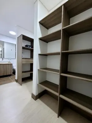 a closet with wooden shelves in a room at New Luxury 3 Bedroom Apartment in Great Area. in Medellín