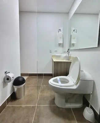 a bathroom with a toilet and a sink at New Luxury 3 Bedroom Apartment in Great Area. in Medellín